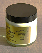 Load image into Gallery viewer, Jar of wood and leather care cream with a black lid on a gold background